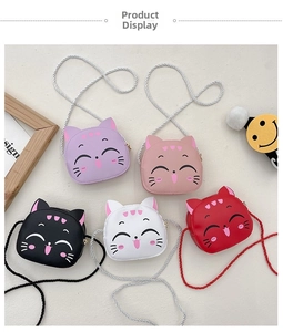 Detailed top view of five colorful cartoon cat crossbody bags with zipper and rope straps