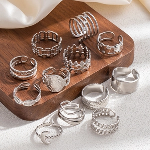 Detail of 11-piece silver stainless steel ring set with crown and moon motifs