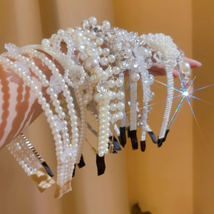 Detail view of handmade pearl headbands and rhinestone tiaras for women's hair accessories