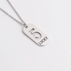Detail of silver titanium steel pendant featuring hollow number 5 and lucky engraving