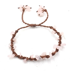 Detail of handmade woven bracelet with pink rose quartz stones and adjustable brown cord