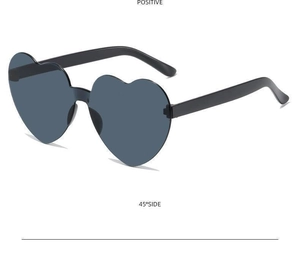 Detail view of black heart-shaped sunglasses with dark grey lenses at a 45-degree angle