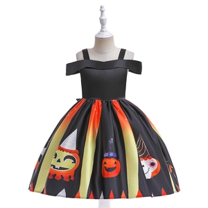 Detail of Halloween girl witch dress showing pumpkin and skull patterns on orange skirt