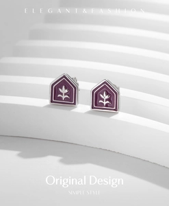 Detailed view of silver tulip enamel earrings on a minimalist architectural prop