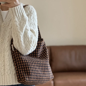 Vintage houndstooth plaid shoulder bag in brown and orange tones shown with a model