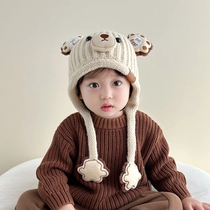 Beige baby winter knit hat with bear ears and chin straps for warmth and protection