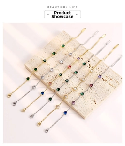Detail of colorful heart-cut zirconia charms on gold and silver stainless steel chains