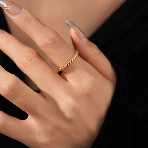 Detailed macro view of a minimalist gold beaded ring featuring elegant polished tiny spheres