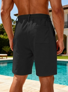 Detail of men's black quick-dry shorts featuring a rear pocket and elastic waistband