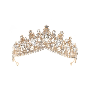 Close-up of golden baroque bridal crown with pear-cut crystals and sparkling rhinestones