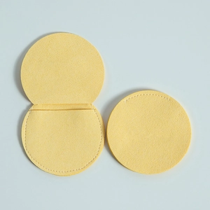 Macro shot of yellow microfiber round jewelry pouch showing open and closed states
