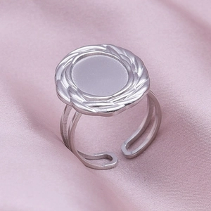 Detail of silver stainless steel ring featuring a braided texture and adjustable band