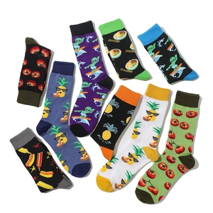 Flat lay of cotton socks with funny fruit and alien patterns featuring elastic ribbed cuffs