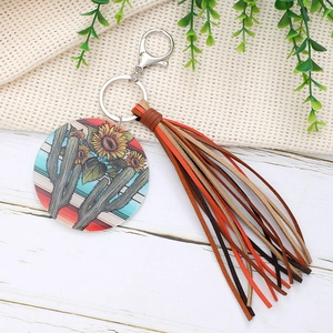 Acrylic keychain with cactus and sunflower prints, featuring colorful tassels and ring
