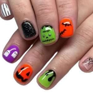 Short Halloween press-on nails with pumpkin ghost and bat designs for festive manicure