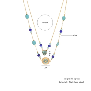 Detail view of double-layer stainless steel necklace with turquoise beads and sun pendant