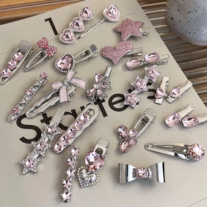 Flat lay of pink heart and star crystal hair clips with silver alloy finish and rhinestones