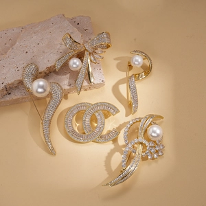 Elegant 14k gold plated brooch collection with pearls and sparkling cubic zirconia