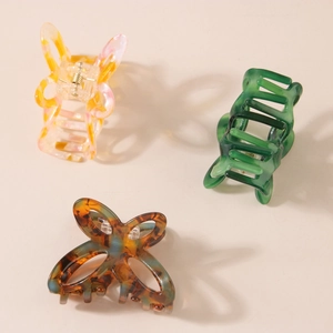 Three acetate butterfly and geometric hair claws in marble and tortoiseshell patterns