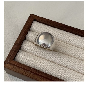 Close-up of polished S925 sterling silver chunky ring inside a premium wooden jewelry box