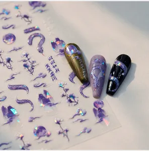Macro view of holographic snake nail art decals with Chinese cloud patterns on various nail tips