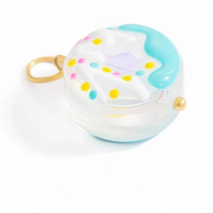 Detail shot of a colorful donut glass pendant with a gold metal ring for DIY jewelry