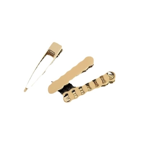 Golden metal alligator hair clips set with smooth and wave edge designs on white background