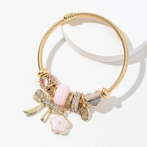 Gold-plated DIY charm bracelet featuring pink enamel flowers and crystal bow pendants