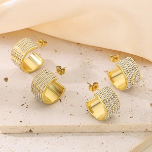 Luxurious gold C-shaped titanium earrings with four rows of sparkling white rhinestones