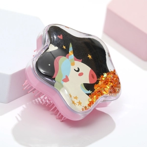 Detail of star-shaped hairbrush featuring a unicorn motif and sparkling sequins