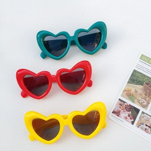 Vertical display of colorful heart-shaped kids sunglasses with UV400 protection