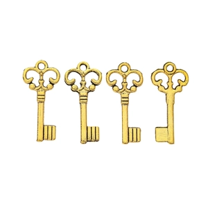 Detailed view of four vintage golden alloy heart-shaped crown key pendants for DIY jewelry
