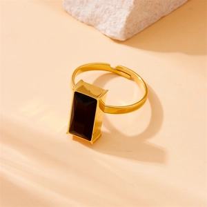 Close-up of gold-plated stainless steel ring with rectangle black stone and stone decor