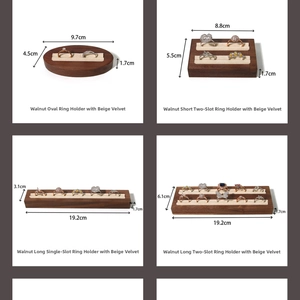 Detail of walnut wood ring display trays with beige velvet slots in multiple sizes