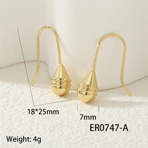 Macro detail of gold teardrop earrings showing 18x25mm size and textured metallic finish