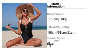 Detail of black one-piece swimsuit featuring sheer mesh waist and white trim details