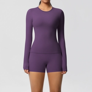Detail of deep purple long-sleeve yoga set showing matte high-stretch fitness fabric