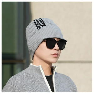 Close-up of grey knit beanie with textured ribbing and FARD letter label detail