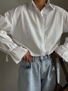 White textured cotton shirt with flared lace-up sleeves and single-breasted button detail