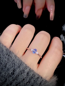Close-up of s925 silver ring with tanzanite purple zircon worn on a hand