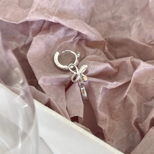 Elegant 925 sterling silver butterfly drop earrings with S925 hallmark on pink background