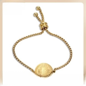 Detail of adjustable golden box chain bracelet featuring a vintage saint coin pendant