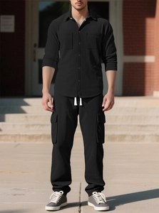 Detailed texture of black vertical striped corduroy fabric on a casual men's tracksuit