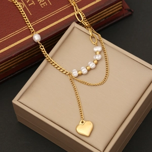 Golden double-layer necklace with pearls and a heart pendant engraved with LOVE