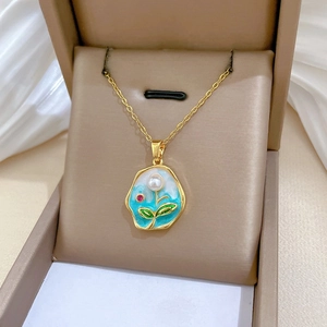 Artistic gold necklace with blue enamel pendant and white pearl in a premium jewelry box