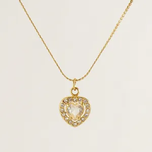 Elegant gold titanium heart necklace featuring a halo crystal pendant on a delicate chain