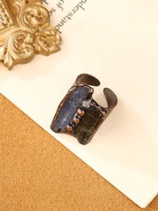 Detail view of vintage bronze open ring with blue and green rectangular natural stones