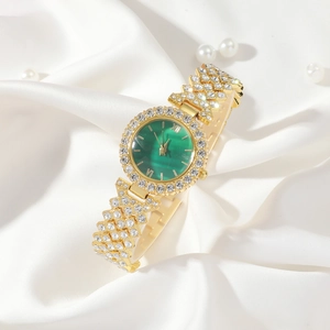 Detailed macro of gold watch with green dial, rhinestones and silk background