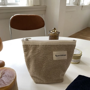 Detail of beige corduroy makeup bag with zipper and Big star & little moon label