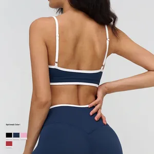 Women's back view of navy blue seamless yoga set with contrast straps and leggings
